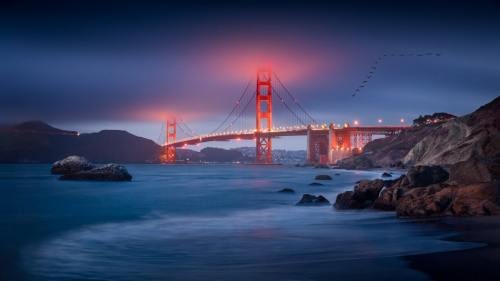 Classic shot of the Golden Gate in San Francisco, at blue hour, with low clouds illuminated by touching the bridge's pylons Classic shot of the Golden Gate in San Francisco, at blue hour, with low clouds illuminated by touching the bridge's pylons